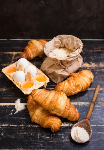 Croissants, flour, eggs, spoon, rolling pin — Stock Photo, Image