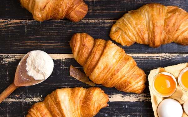 Croissants, flour, eggs, spoon, rolling pin — Stock Photo, Image