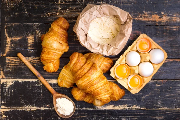 Croissants, flour, eggs, spoon, rolling pin — Stock Photo, Image