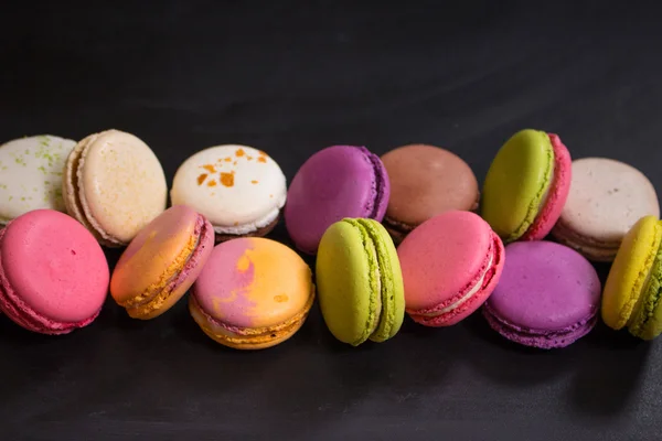 Assorted colorful macaroons on a dark background — Stock Photo, Image