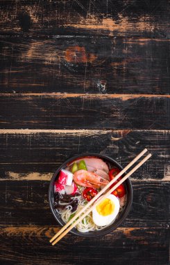 Siyah bir kabın içinde Asya şehriye çorbası