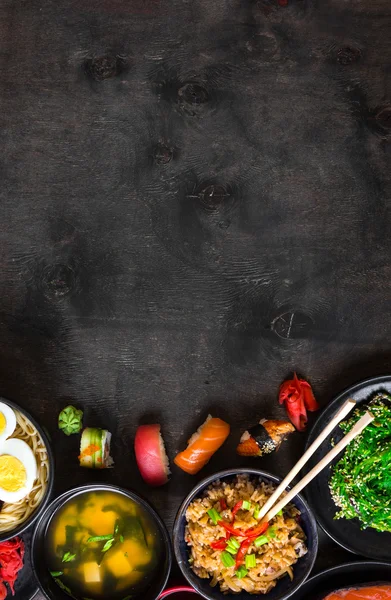 Суши и японская еда на тёмном фоне — стоковое фото