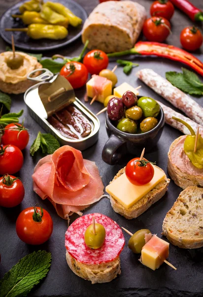 Spanish tapas on a black stone — Stock Photo, Image