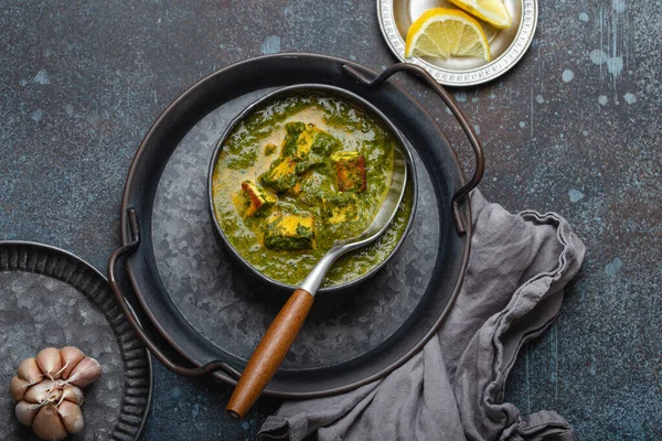 Indian dish Palak Paneer in bowl on rustic stone table — Stock Photo, Image
