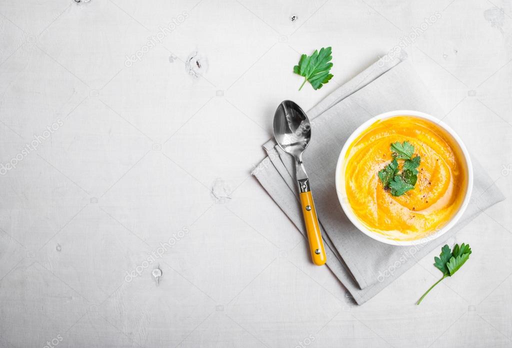 Pumpkin soup with parsley background