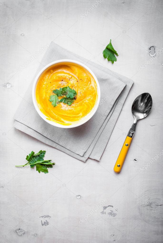 Pumpkin soup with parsley background