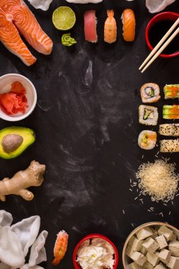 Sushi and ingredients on dark background clipart