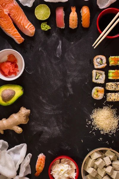 Sushi and ingredients on dark background — Stock Photo, Image