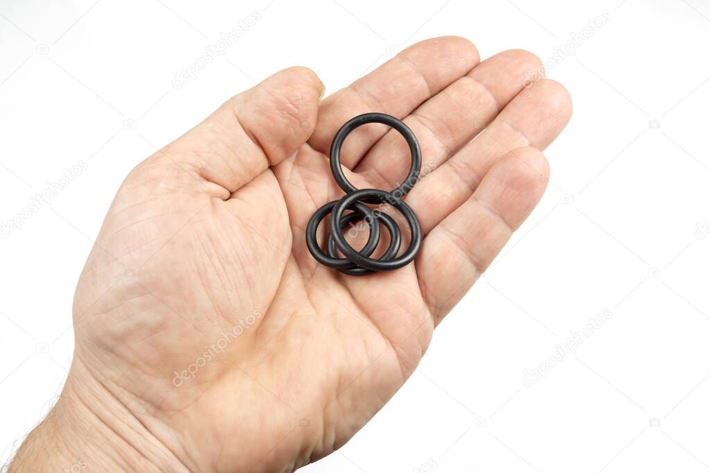 Rubber o-rings, several pieces in a man's hand