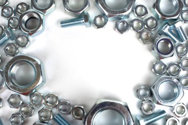 Beyaz arka planda metalden yapılmış cıvatalar ve fındıklar.