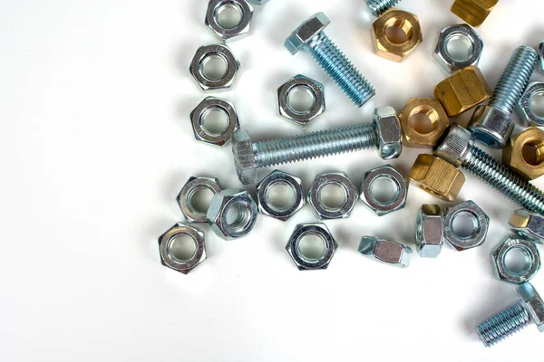 bolts and nuts made of metal on a white background