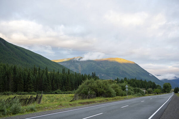 the morning sun illuminates the peaks of distant mountains