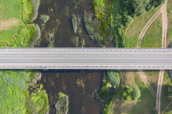 Aerial top down view of empty bridge. River flowing under bridge