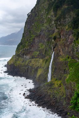 Veu da Noiva waterfall flowing into the Atlantic Ocean in Madeira, Portugal