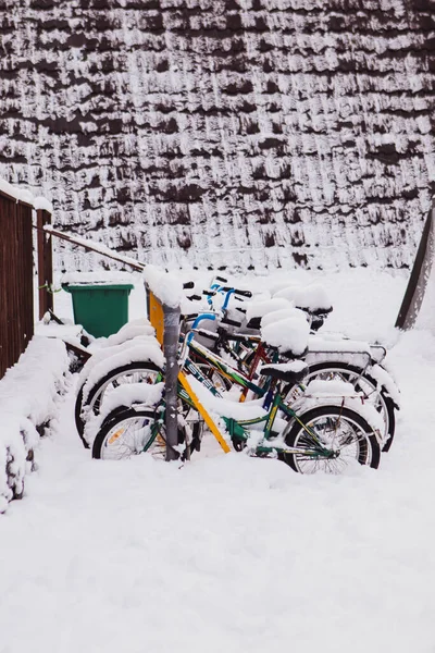 Bicycles covered by the snow. Cold outside. Urban landscape