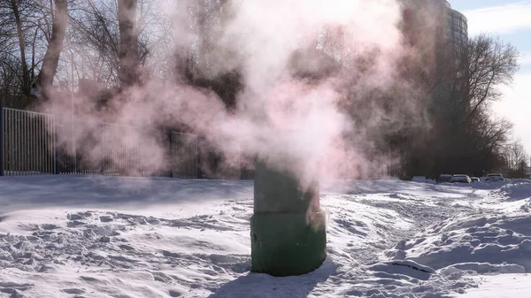Frozen water vapour green pipe from ventilation exhaust in sunny winter Moscow