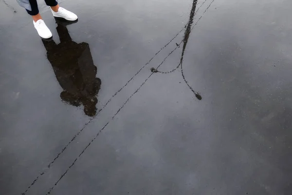 湿淋淋的沥青路面上的莫斯科街道 女孩和她的腿的反光 — 图库照片
