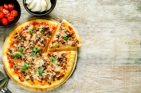 pizza with meat, mozzarella and oregano