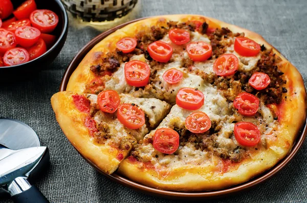 pizza with meat, mozzarella and tomatoes