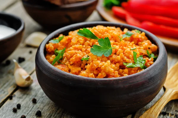 Millet porridge with tomato sauce, garlic and parsley — Stock Image Millet porridge with tomato sauce, garlic and parsley Royalty Free Stock Images