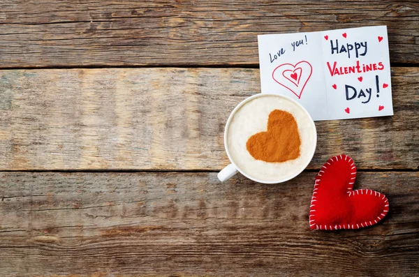 card for Valentines day, red toy heart and a cup of coffee