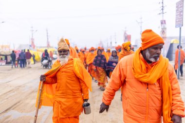Prayagraj, Uttar Pradesh, Hindistan - 15 Ocak 2025: Mahakumbh, Pereagraj 'da kutsal hamama ibadet etmek ve ayinleri gerçekleştirmek için kumbh mela' ya katılan kutsal erkek ve kadın grubu.