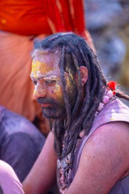 Varanasi, Uttar Pradesh, Hindistan - 21 Mart 2024: Masan Holi, Manikarnika ghat kutlamaları sırasında yüzü organik renklerle boyanmış bir grup dindar..