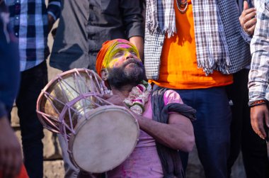 Varanasi, Uttar Pradesh, Hindistan - 21 Mart 2024: Masan Holi, Manikarnika ghat kutlamaları sırasında yüzü organik renklerle boyanmış bir grup dindar..