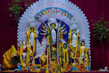 Navratri için dekore edilmiş güzel el yapımı renkli bir tanrıça Durga idolü. Renkli pandallarda canlı geleneksel kıyafetler, karmaşık mücevherler ve ilahi ifadeler içeriyor..