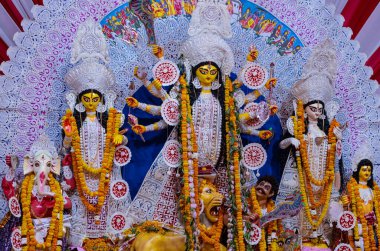 Navratri için dekore edilmiş güzel el yapımı renkli bir tanrıça Durga idolü. Renkli pandallarda canlı geleneksel kıyafetler, karmaşık mücevherler ve ilahi ifadeler içeriyor..