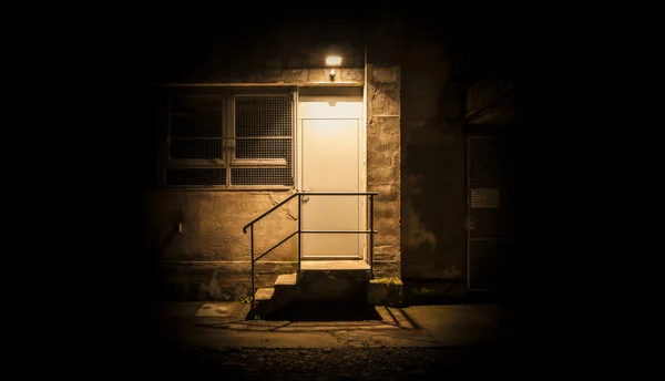 Stairs and door illuminated in the night — Stock Photo, Image