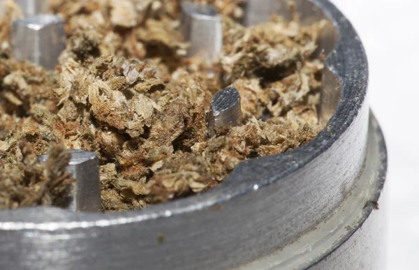 Close-up of a metal grinder with marijuana — Stock Photo, Image