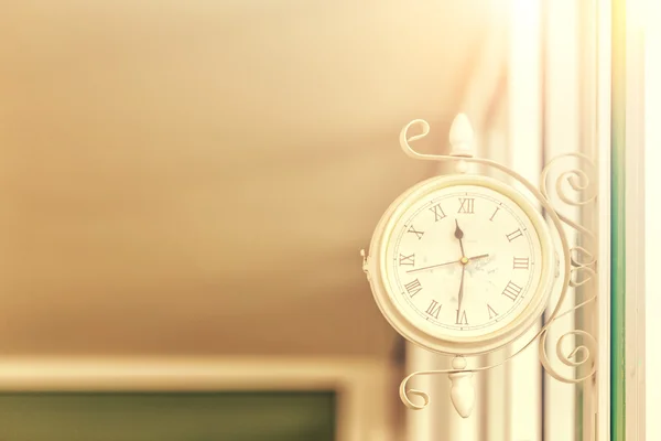 Reloj retro cuelga en la pared con luz del día —  Fotos de Stock