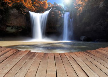Dreaming of water fall on a empty wooden pier clipart