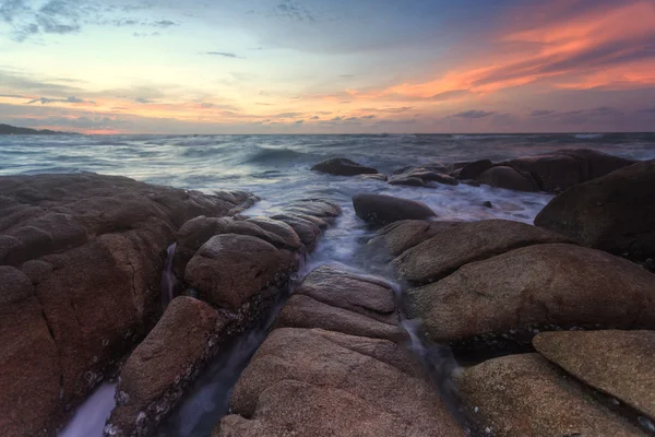 Beautiful sunset at the stone beach — Stock Photo, Image