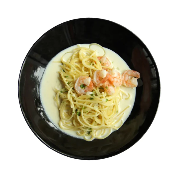 White cream sauce spaghetti with shrimp recipe in black plate is — Stock Photo, Image