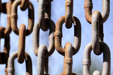 Paslı zinciri mavi gökyüzü arka plan üzerinde asılı.