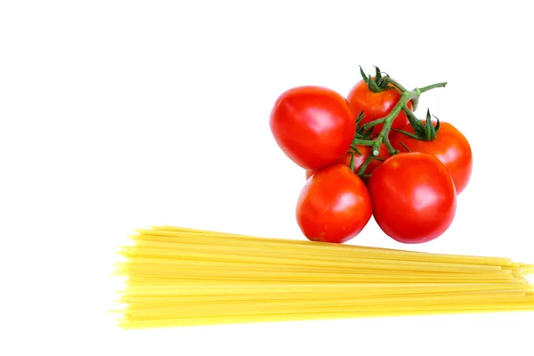 Tomatoes and raw pasta — Stock Photo, Image