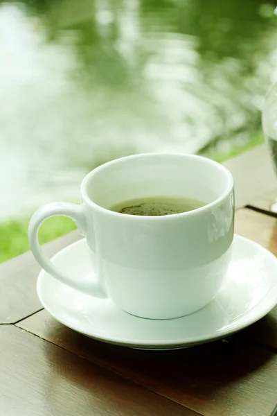 Tazza di caffè su tavolo in legno in giardino . — Foto Stock