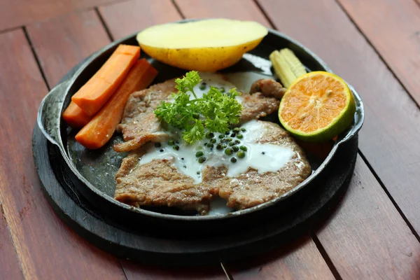 Grilled steaks, baked potatoes and vegetables. — Stock Photo, Image