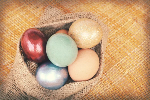 Vintage paper texture, colorful easter eggs in sack bag on weave — Stock Photo, Image