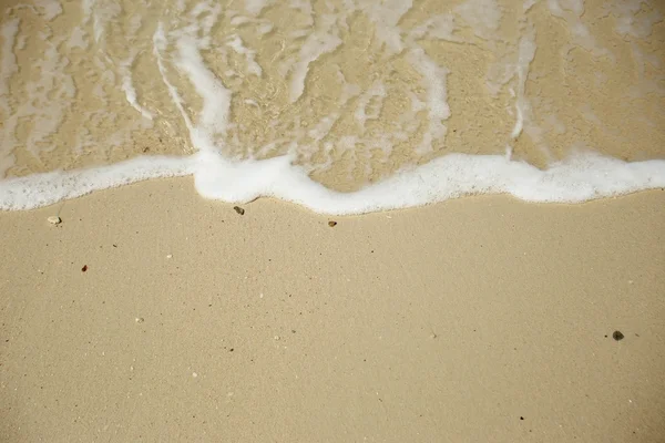 Wave washing up onto sand beach. — Stock Photo, Image