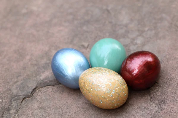 Colorful easter eggs on stone floor. — Stock Photo, Image