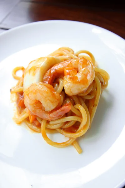 Spaghetti seafood with tomato sauce on white dish. — Stock Photo, Image