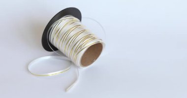 Beyaz izole edilmiş arka planda hediyeler için ince altın ve beyaz paket bandı. Hediye Paketi Kurdelesi