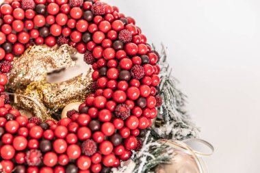 Beyaz arka planda Noel çelengi. Kırmızı çilek çemberi. Boşluğu Kopyala