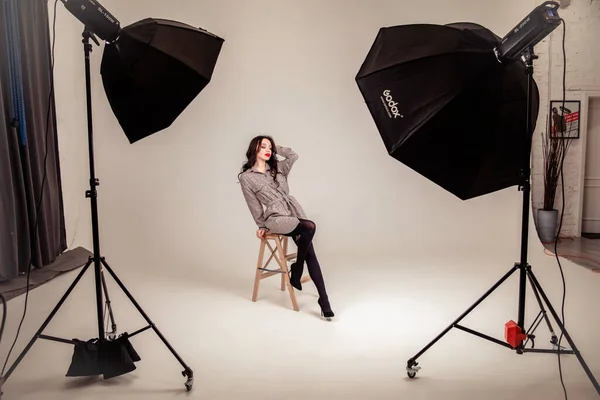 Sexy man and woman doing a fashion photo shoot in a professional studio.