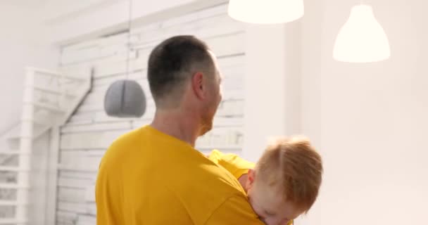 Červený šťastný chlapec v náručí otců. — Stock video