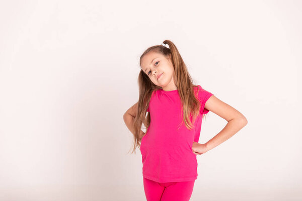 portrait of a beautiful happy girl with tails in a pink T-shirt. Copy space