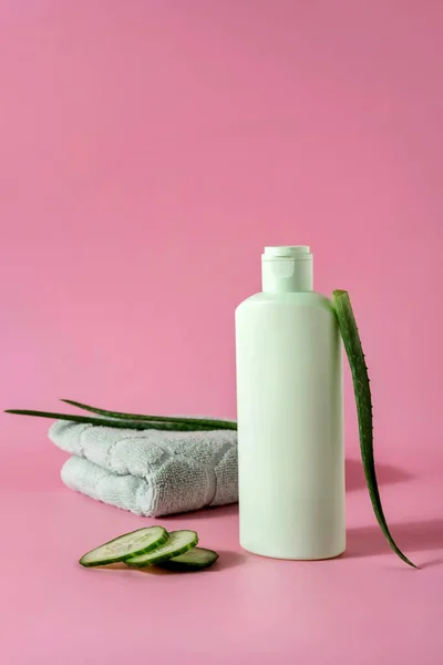 Cosmetic products with aloe vera and cucumber  on pink backgroundr. Space for text.